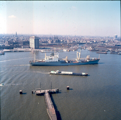 S.9100(7025); Dia van het binnenvaartschip 'Steenwijk' geladen met KNSM-containers het vrachtschip 'Trident Amsterdam' passerende op het IJ; diapositief