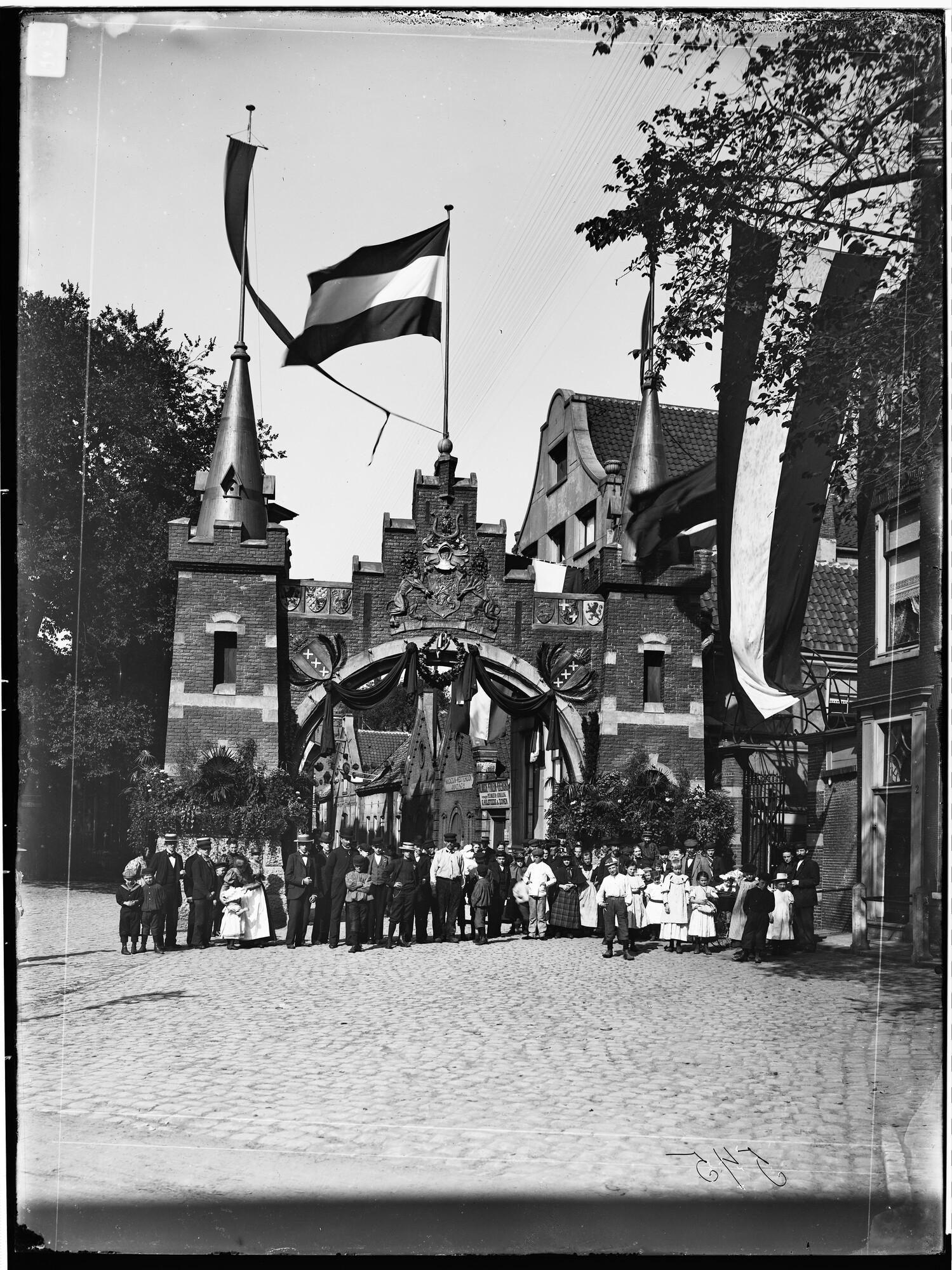 S.1156(06)128-05; Glasnegatief van de inhuldigingsfeesten van koningin Wilhelmina te Amsterdam, groepsportret voor een poort; negatief