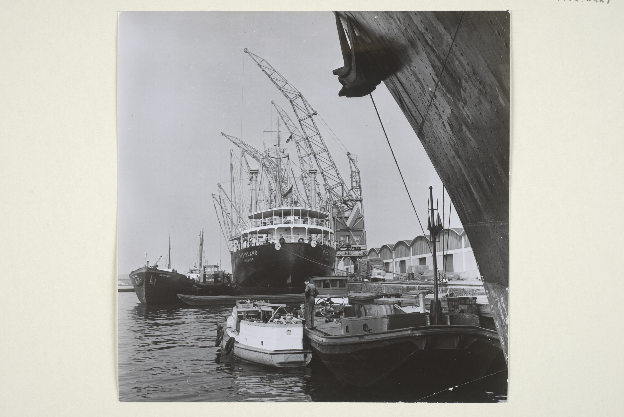 1998.2227; Foto's van de overslag van goederen vanaf het Duitse vrachtschip ms. 'Rheinland' van de Hapag Lloyd A.G. op binnenvaartschepen in de Coenhaven, april 1963; fotoreportage