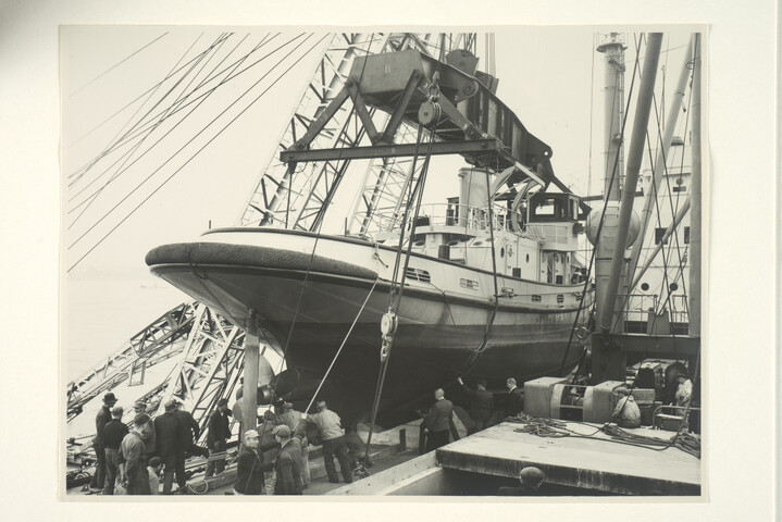 S.5219(12)0045; Foto's van de haven- en zeesleepboot 'S 1' voor het Minog terwijl deze sleepboot in de haven van Rotterdam als deklast aan boord ms. 'Zeeland' wordt gehesen; fotoreportage