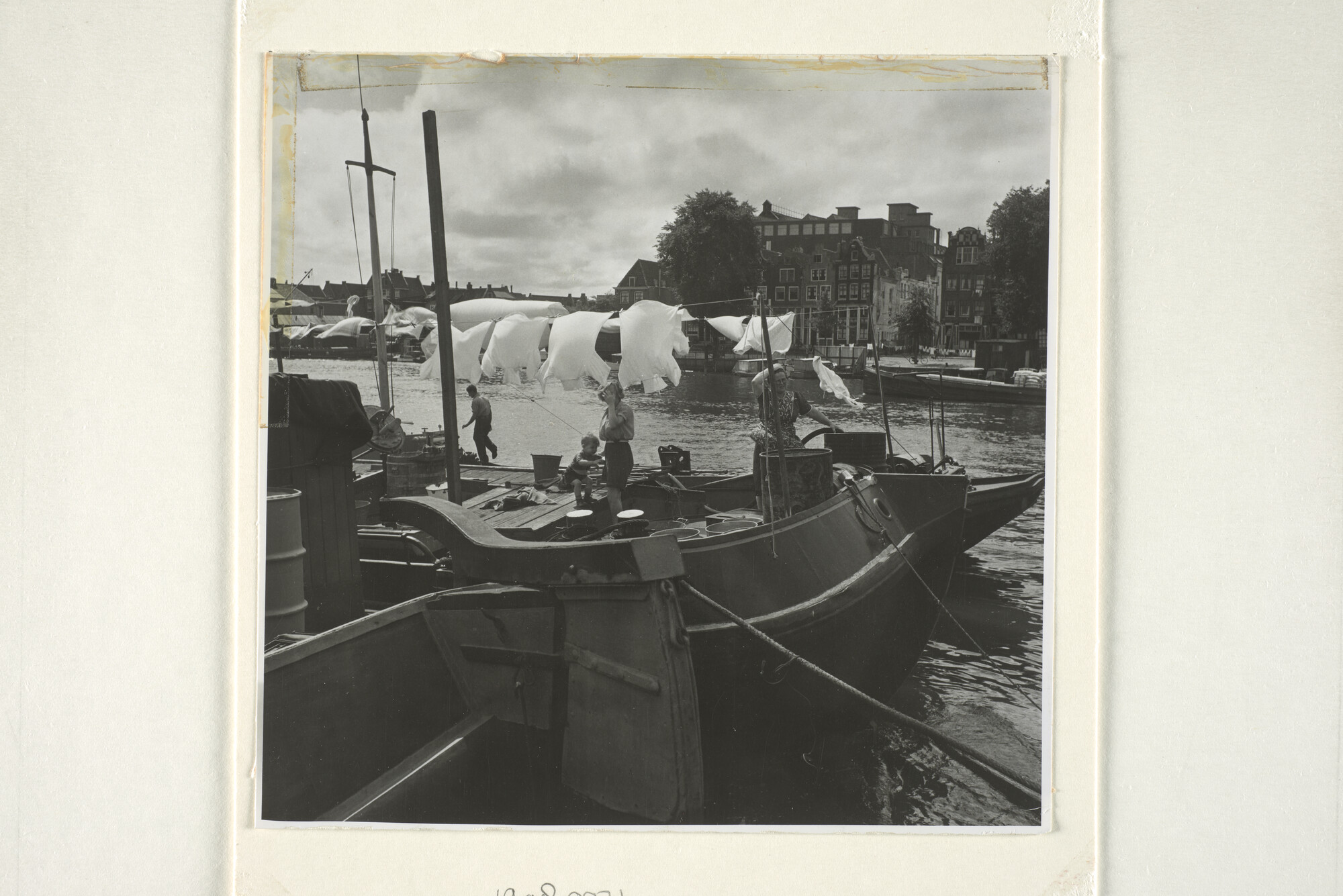 1998.0071; Stadsgezicht in Amsterdam: een schippersfamilie op een binnenvaartschip hangt de was uit bij de Zandhoek [...]; foto