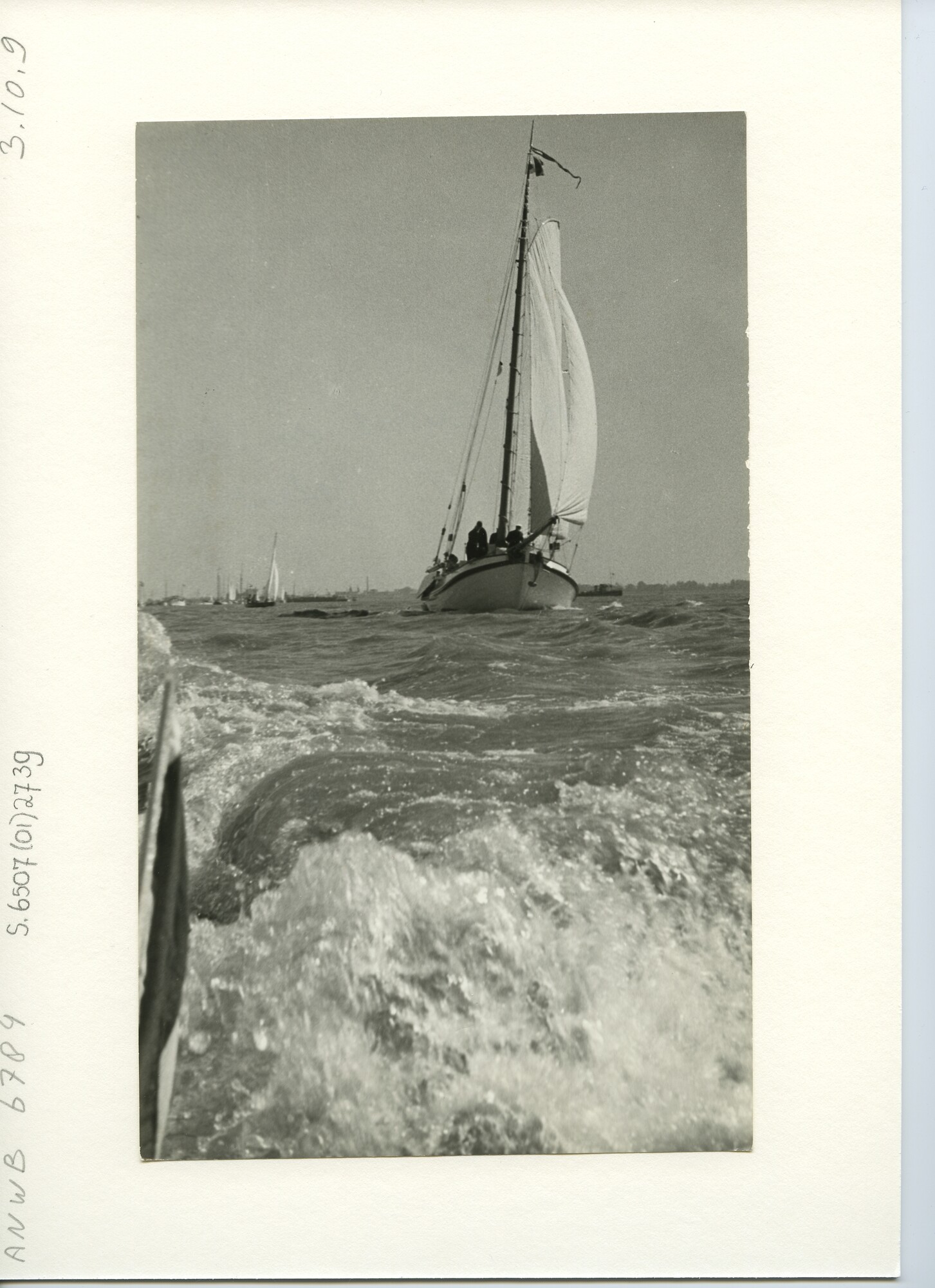 S.6507(01)2739; Vooraanzicht van een wit geschilderde Lemsteraak onder kluiver, fok en grootzeil op open water; foto