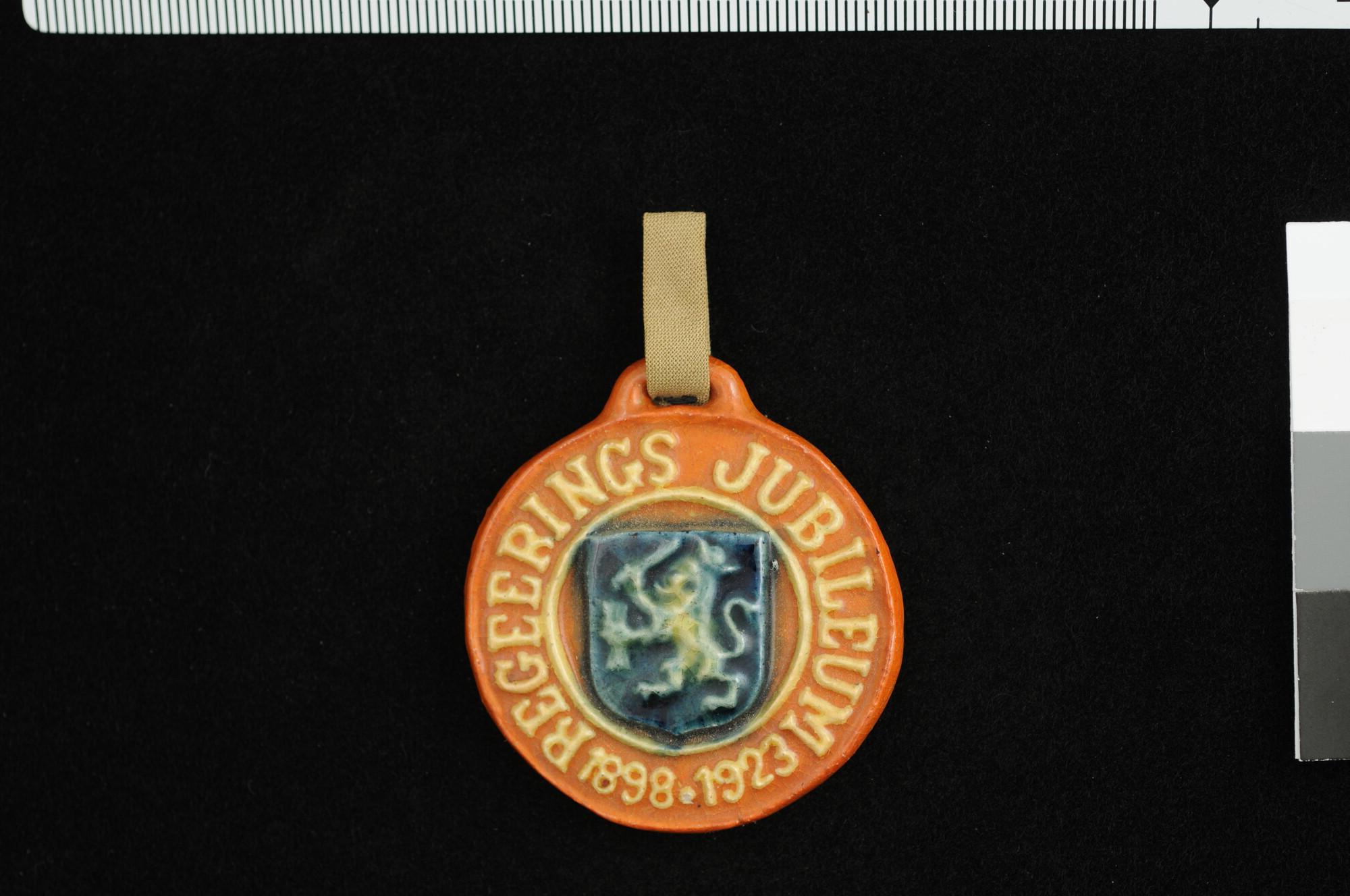 1999.3210; Aardewerken draagteken op het 25-jarig regeringsjubileum van koningin Wilhelmina, 1923; draagteken