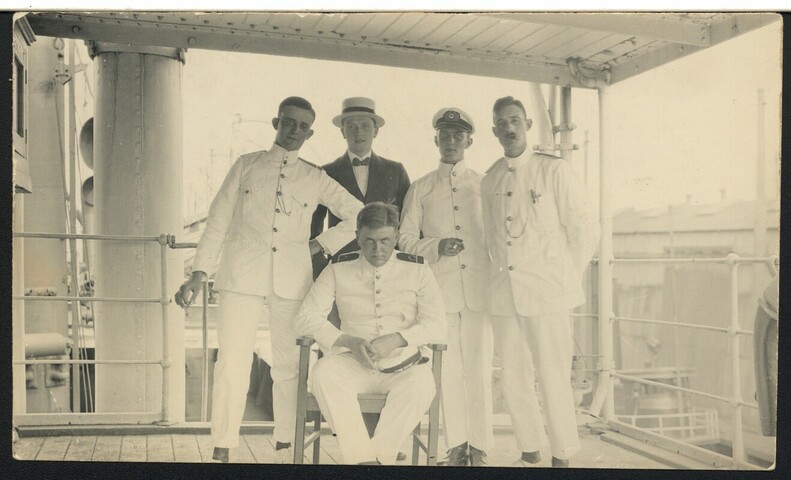 S.6773(16); Prentbriefkaart van een groepsfoto van vijf personen waarvan vier in uniform op ss. 'Schiedijk', mogelijk in de haven van Philadelphia (USA); prentbriefkaart